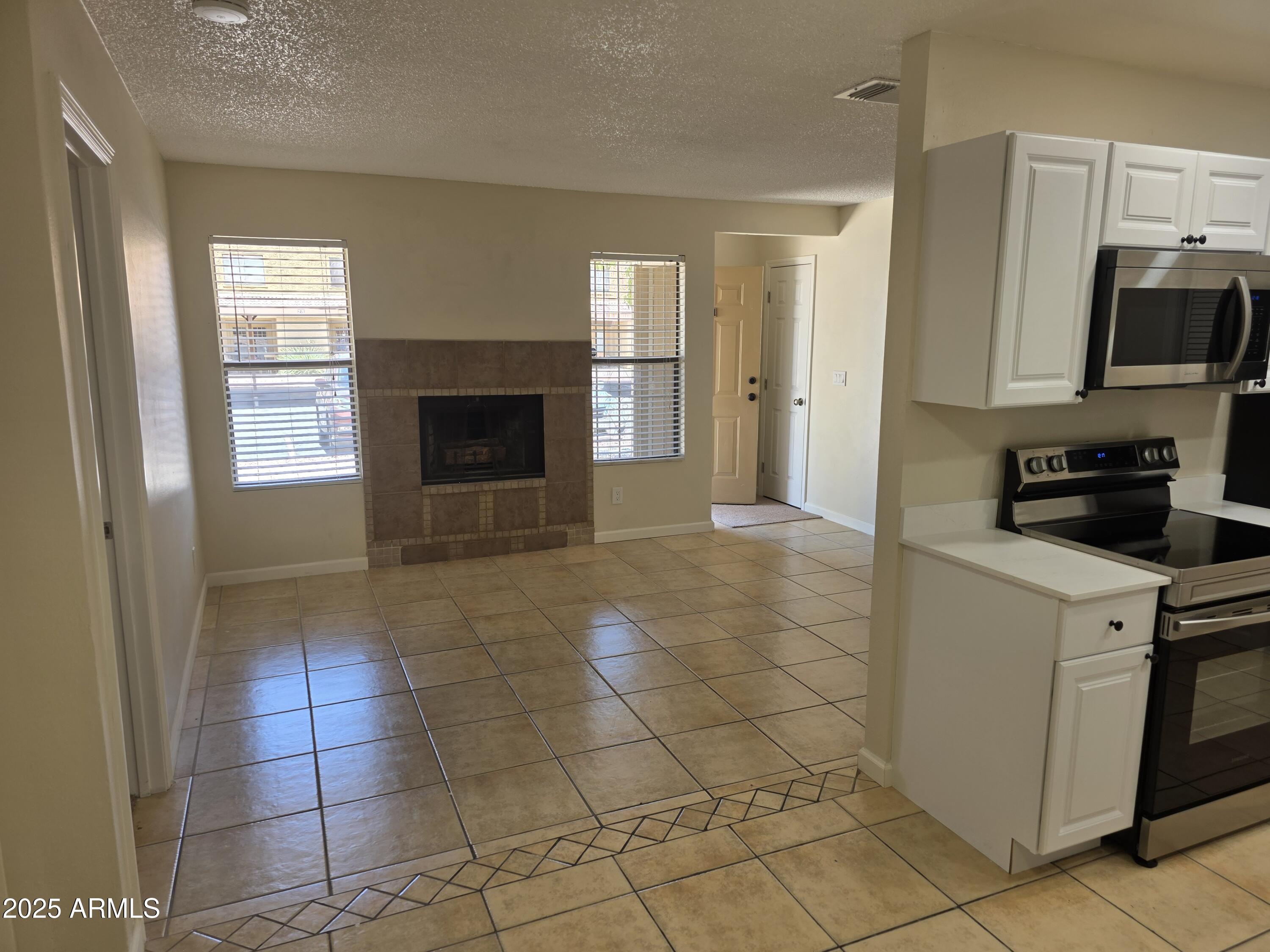 3511 East Baseline Road, Unit 1117 Phoenix, AZ 85042 - Photo 3 of 30 a view of a kitchen with an empty space and a window