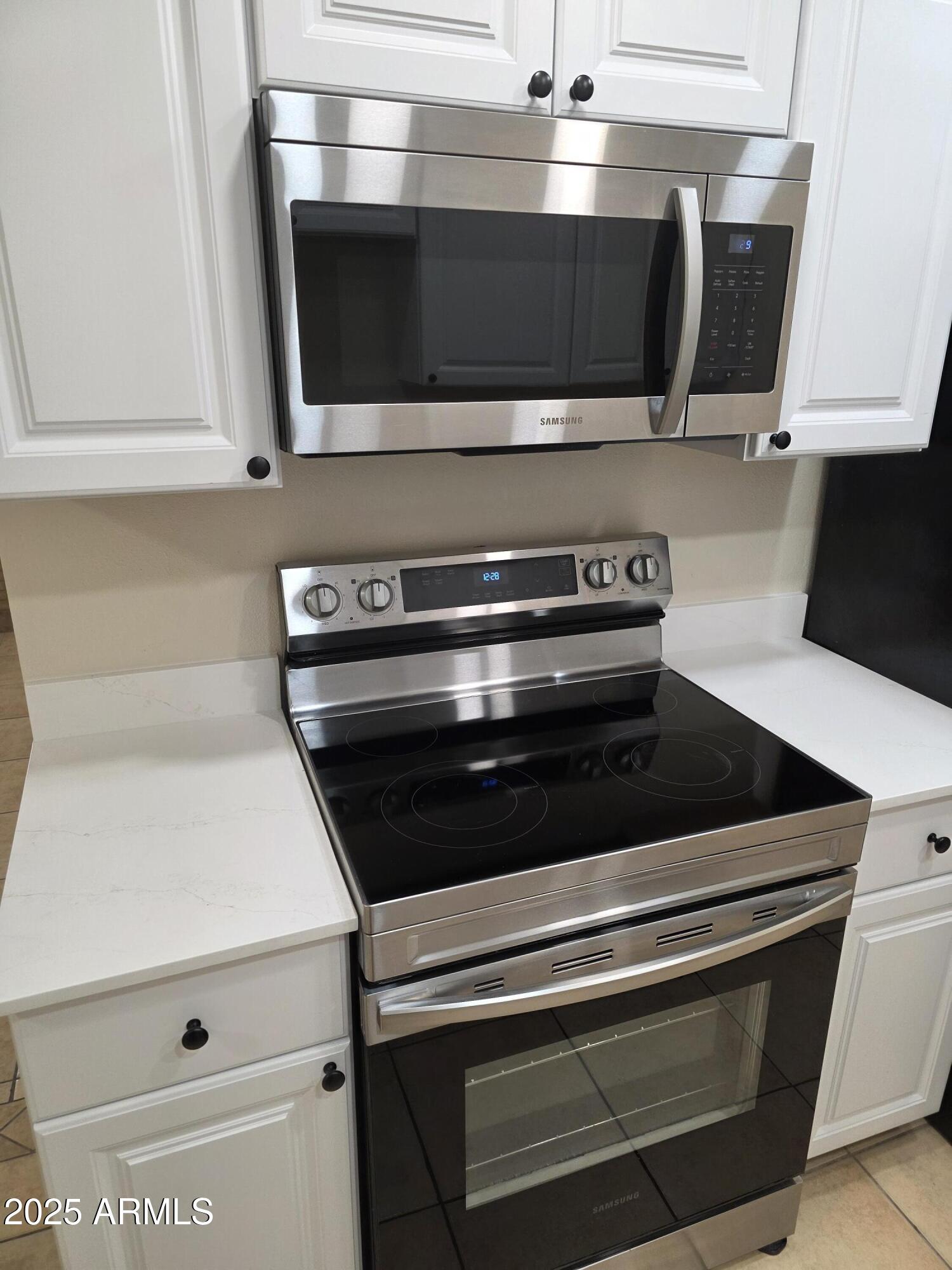 3511 East Baseline Road, Unit 1117 Phoenix, AZ 85042 - Photo 6 of 30 a stove top oven sitting inside of a kitchen