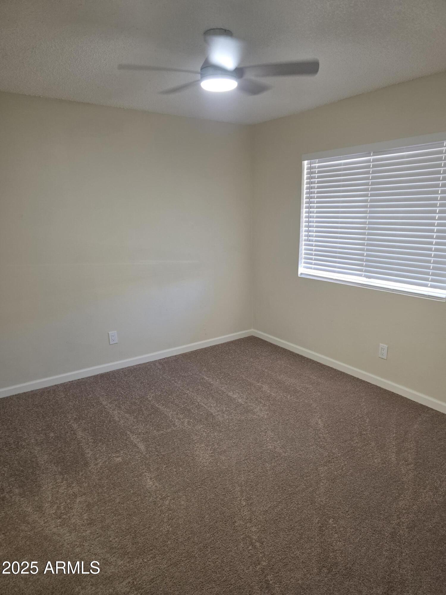 3511 East Baseline Road, Unit 1117 Phoenix, AZ 85042 - Photo 9 of 30 an empty room with a window