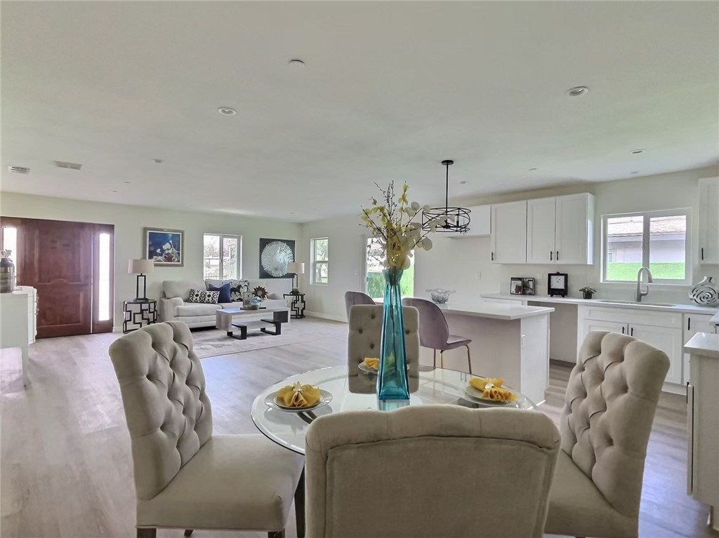 378 Rosa Parks Road Palm Springs, CA 92262 - Photo 2 of 9 a living room with furniture and a dining table with kitchen view