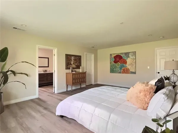 a bedroom with a bed and a couch