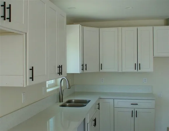 a kitchen with a sink and cabinets