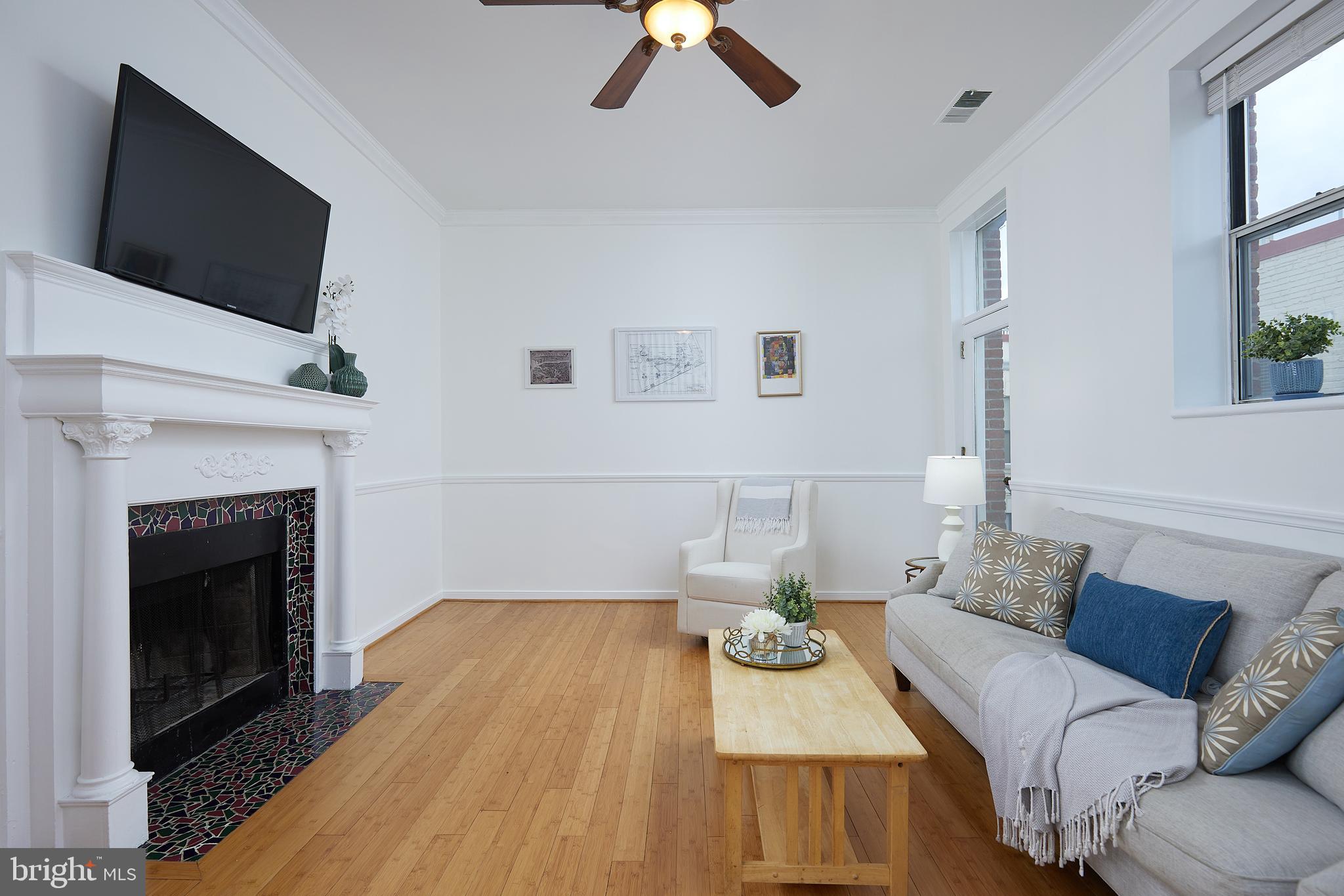 2611 Adams Mill Road Northwest, Unit 405 Washington, DC 20009 - Photo 2 of 38 Living room with wood-burning fireplace