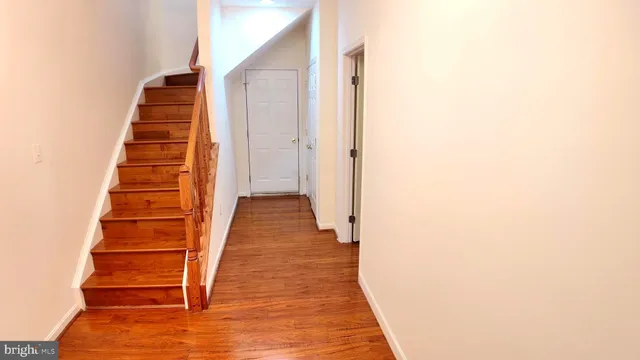 a view of staircase with wooden floor
