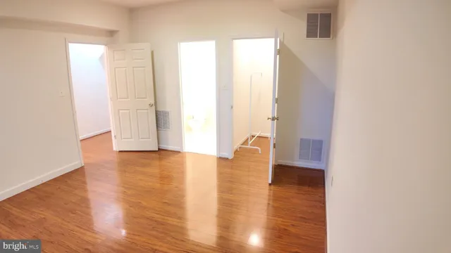 a view of a room with wooden floor