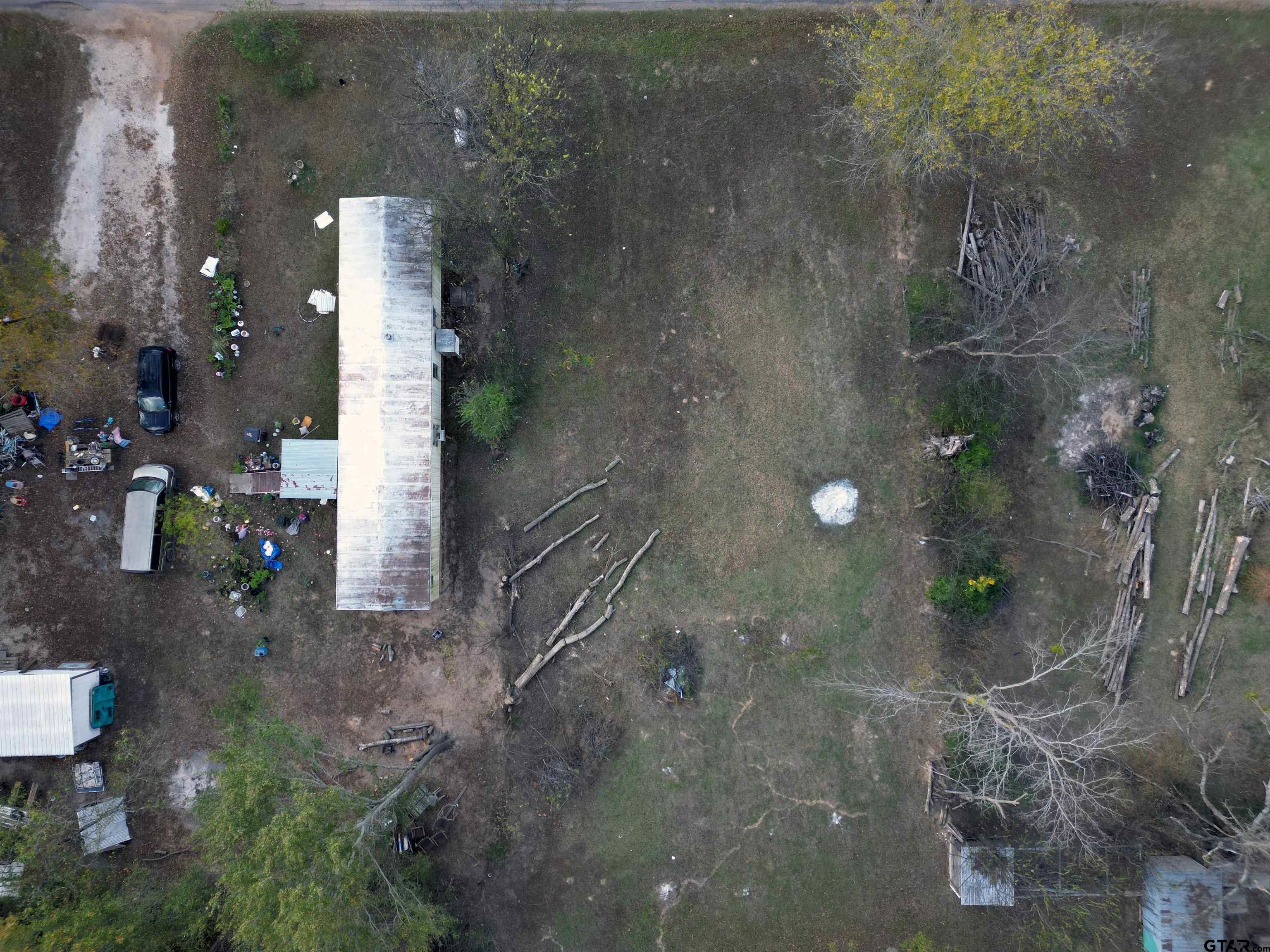 215 Cleveland Street Winfield, TX 75455 - Photo 15 of 17 a partial view of a house with a yard