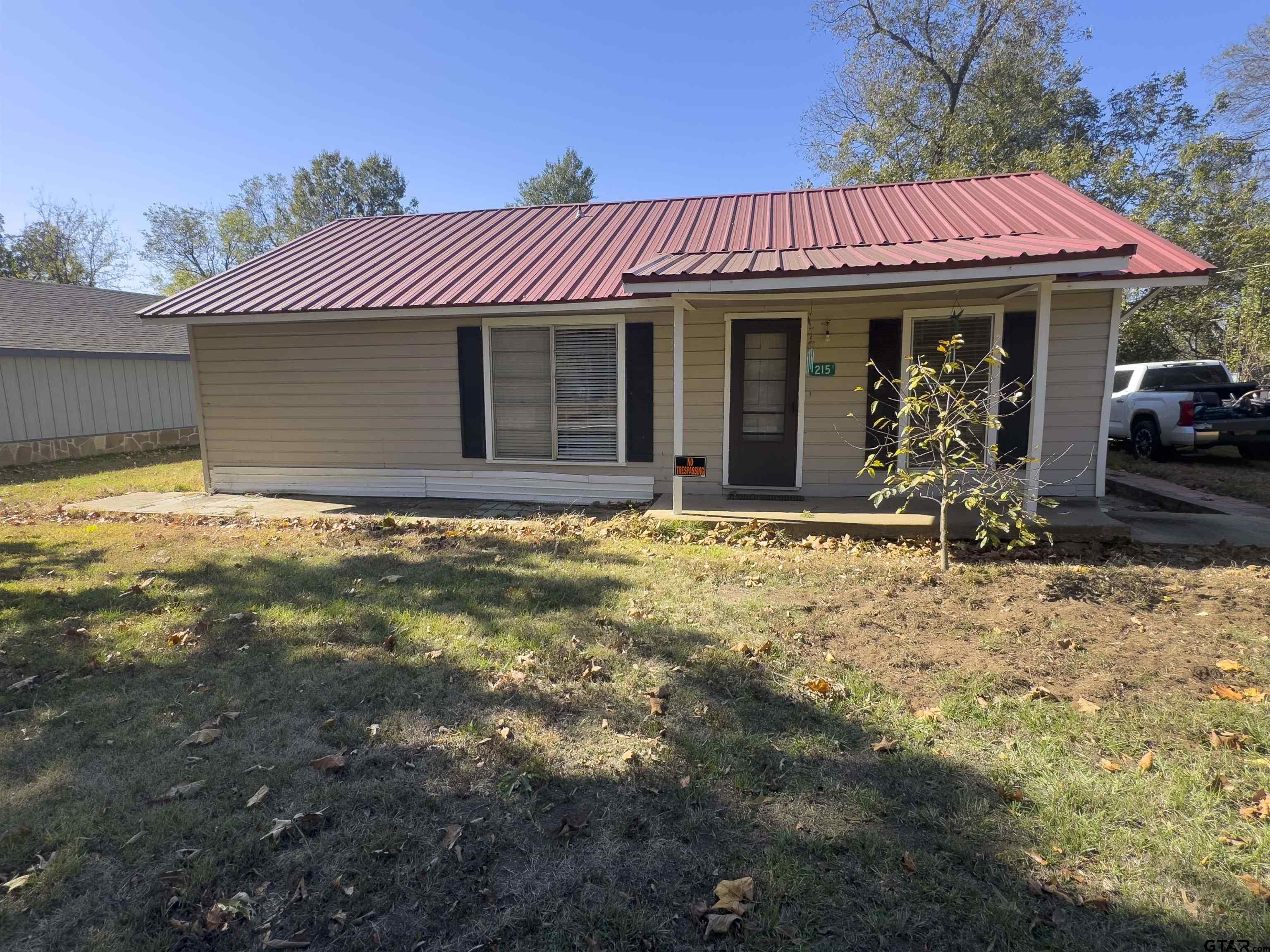 215 Cleveland Street Winfield, TX 75455 - Photo 4 of 17 a view of a house with a yard