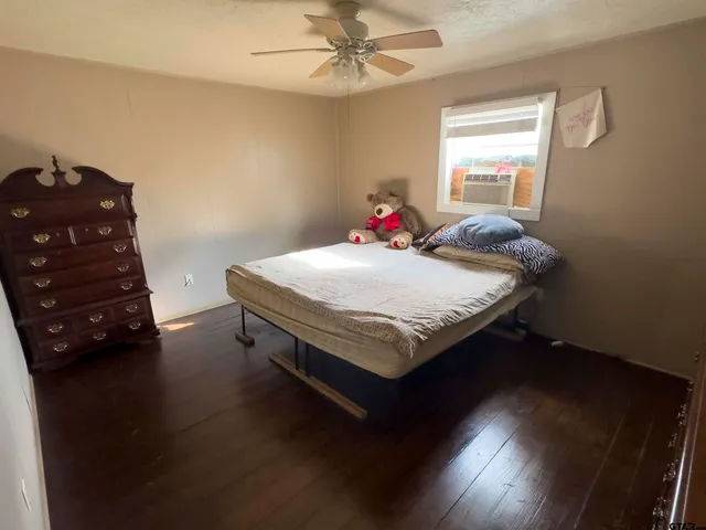 a bed sitting in a bedroom next to a window