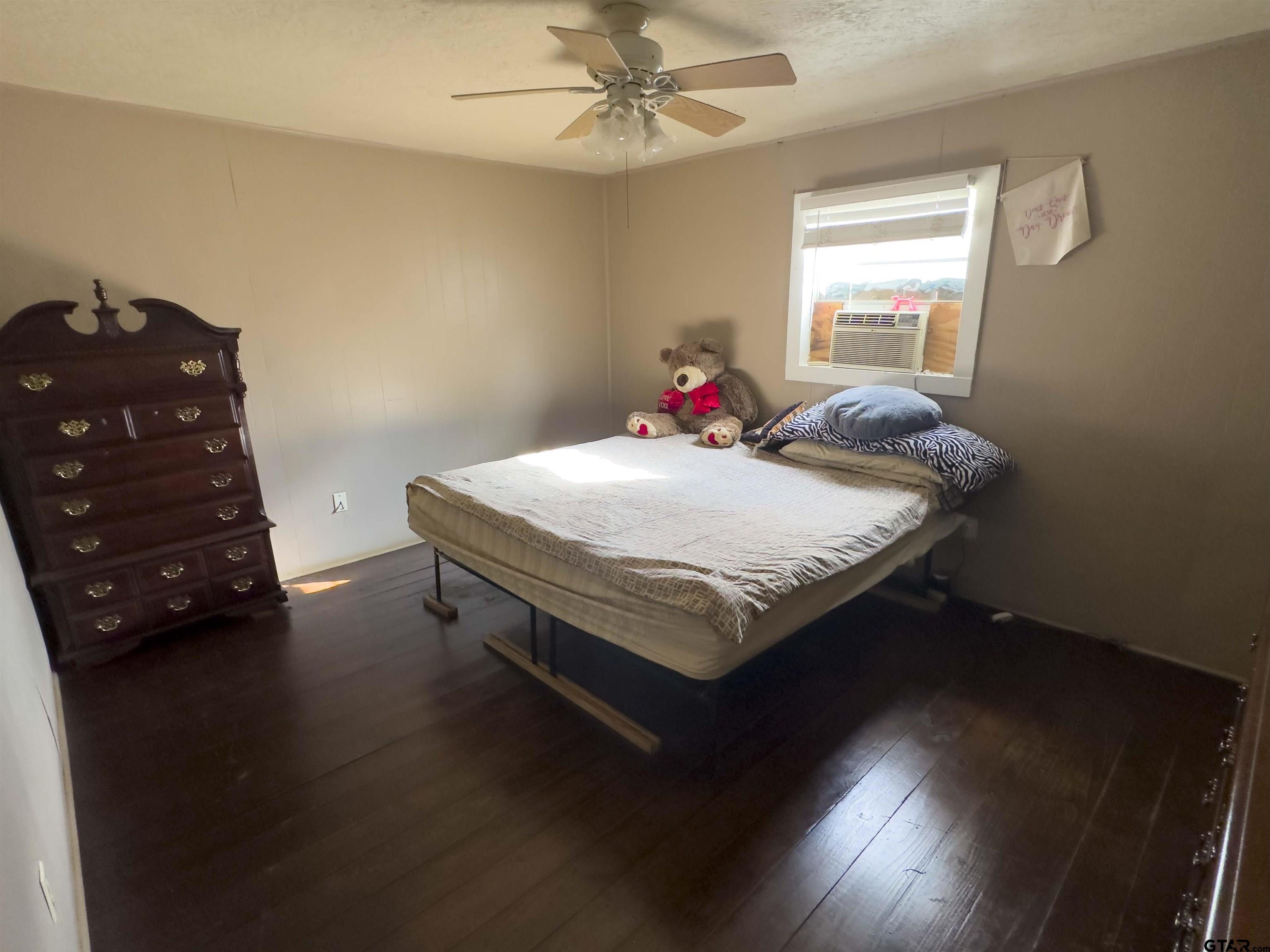 215 Cleveland Street Winfield, TX 75455 - Photo 9 of 17 a bed sitting in a bedroom next to a window