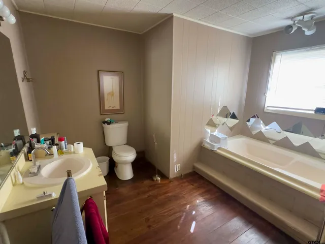 a bathroom with a sink toilet and a mirror