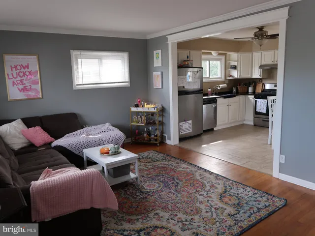 a living room with furniture and kitchen view