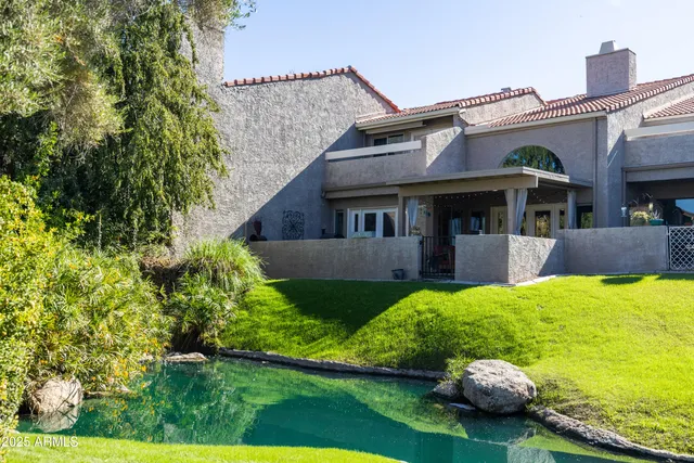 a view of a house with pool and sitting area