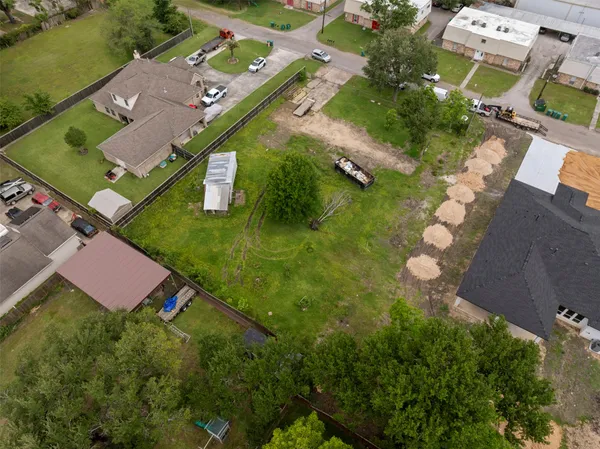 an aerial view of residential houses with outdoor space and street view
