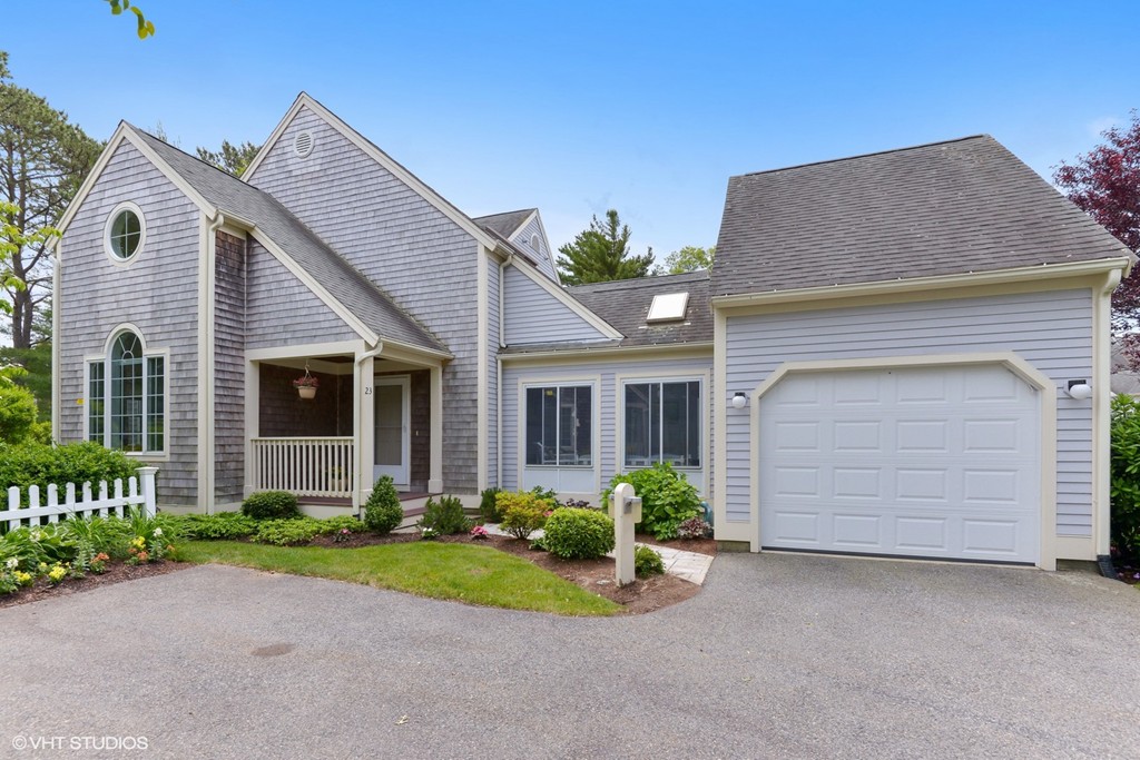 a front view of a house with a garden and plants