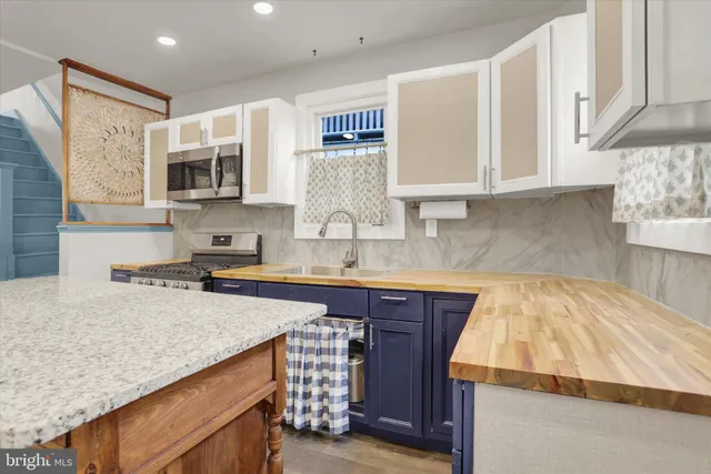 a kitchen with granite countertop a stove and a sink