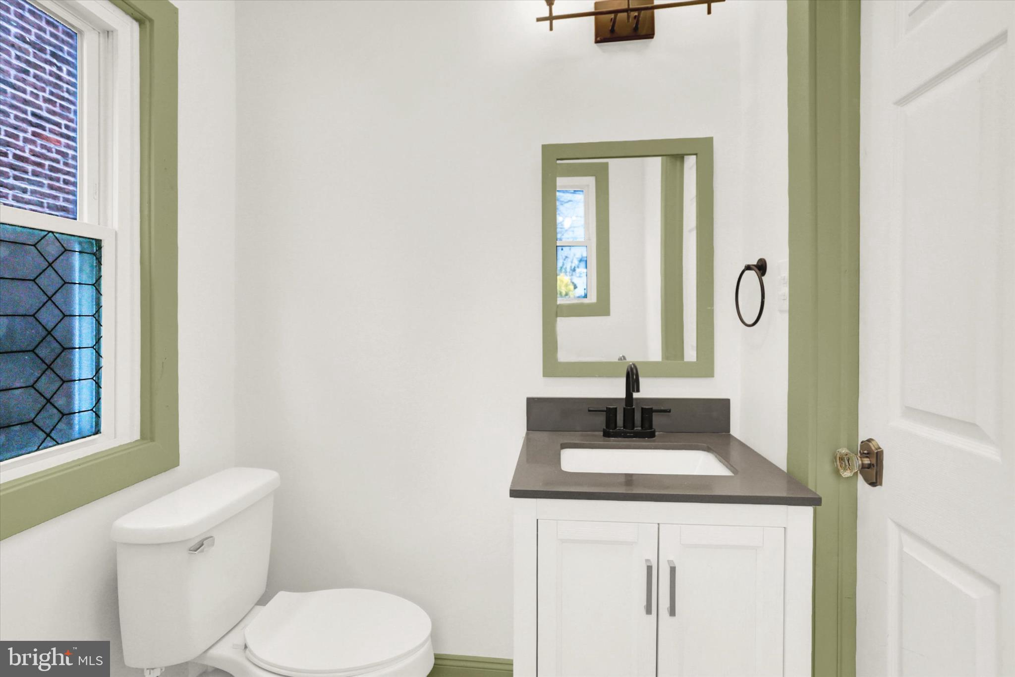 513 Poplar Street Lancaster, PA 17603 - Photo 15 of 41 a bathroom with a toilet sink and mirror