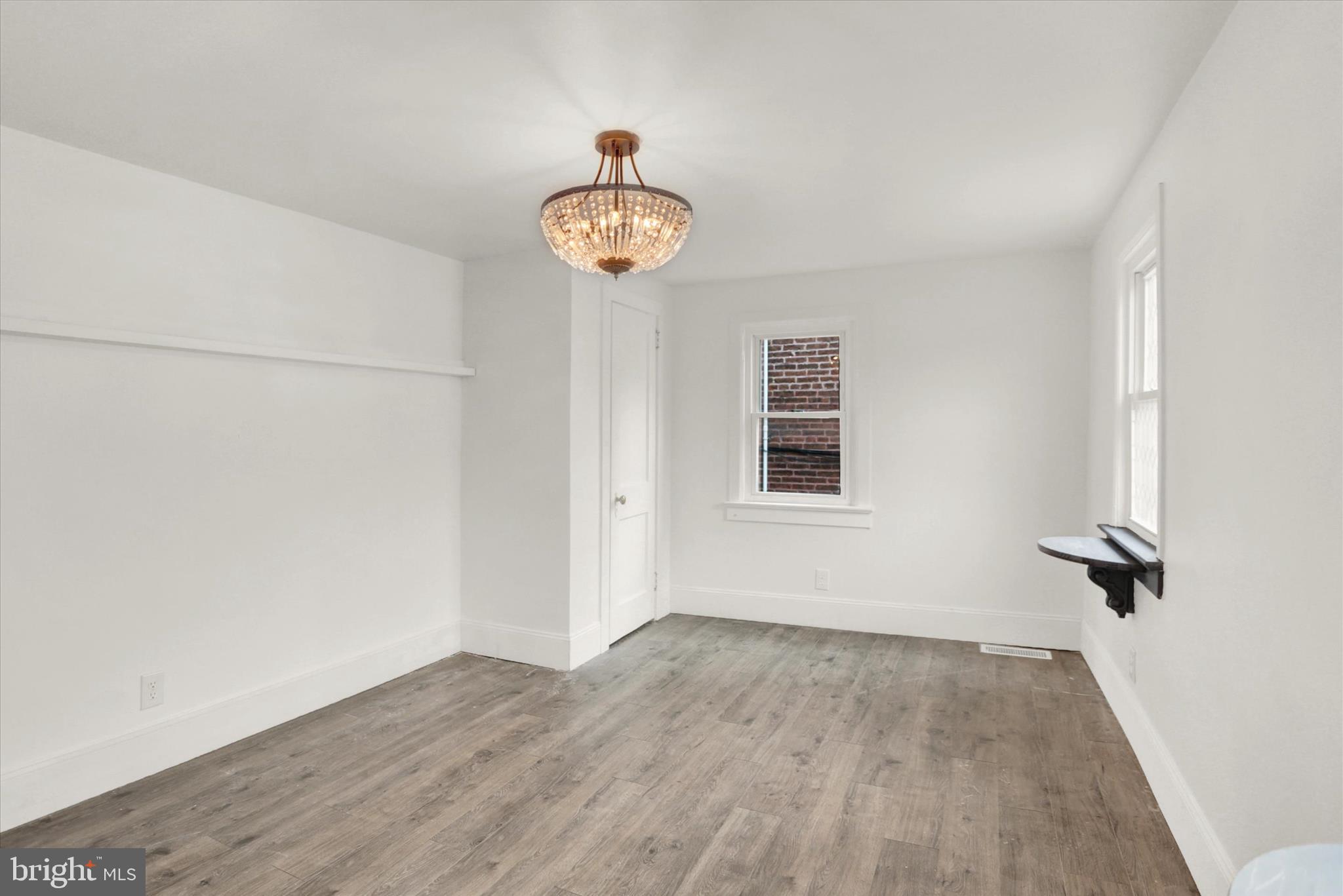 513 Poplar Street Lancaster, PA 17603 - Photo 19 of 41 an empty room with a wooden floor and a window