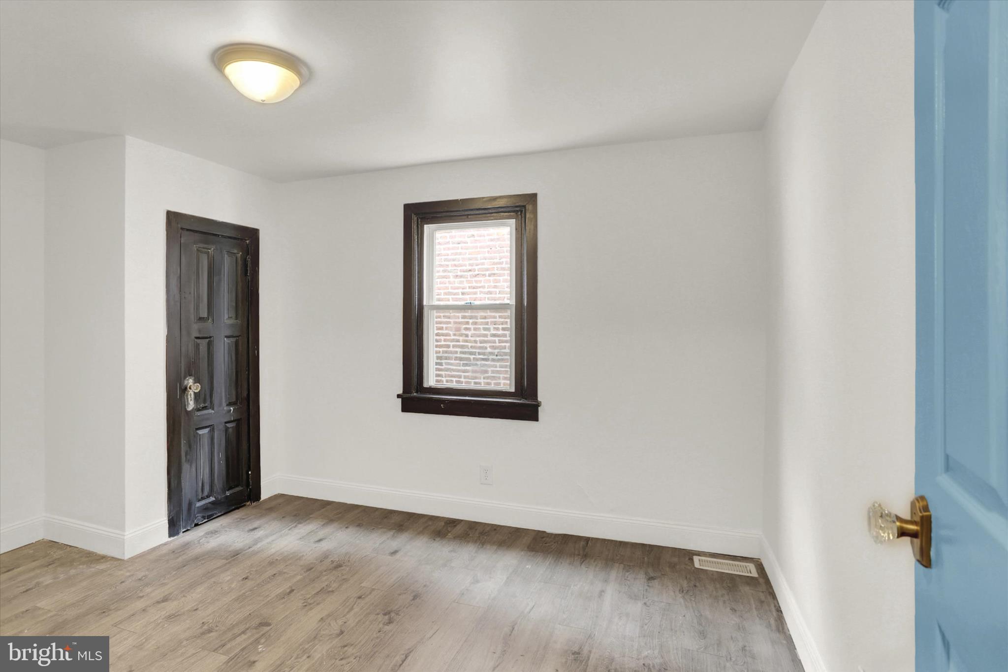 513 Poplar Street Lancaster, PA 17603 - Photo 25 of 41 an empty room with wooden floor and windows