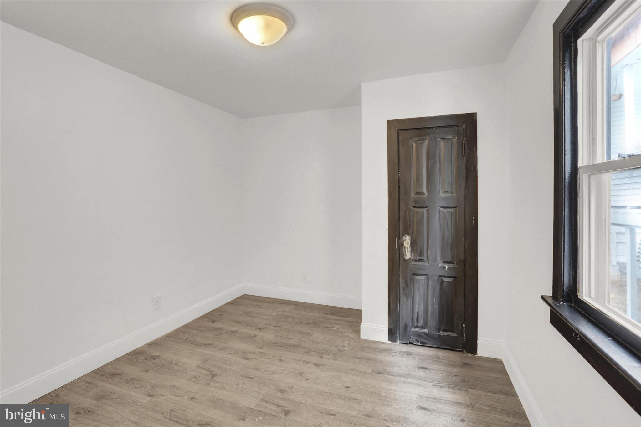 513 Poplar Street Lancaster, PA 17603 - Photo 26 of 41 an empty room with wooden floor and windows