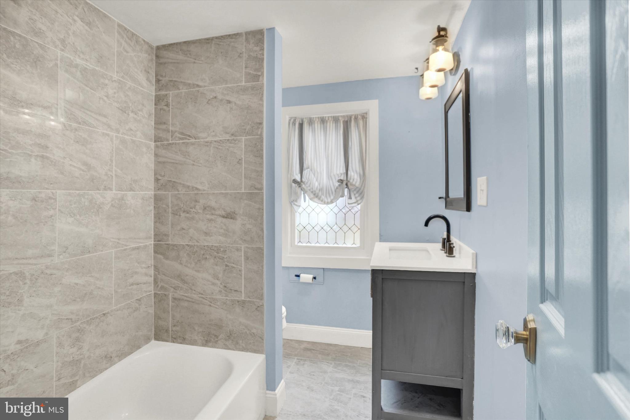 513 Poplar Street Lancaster, PA 17603 - Photo 29 of 41 a bathroom with a sink a toilet and shower