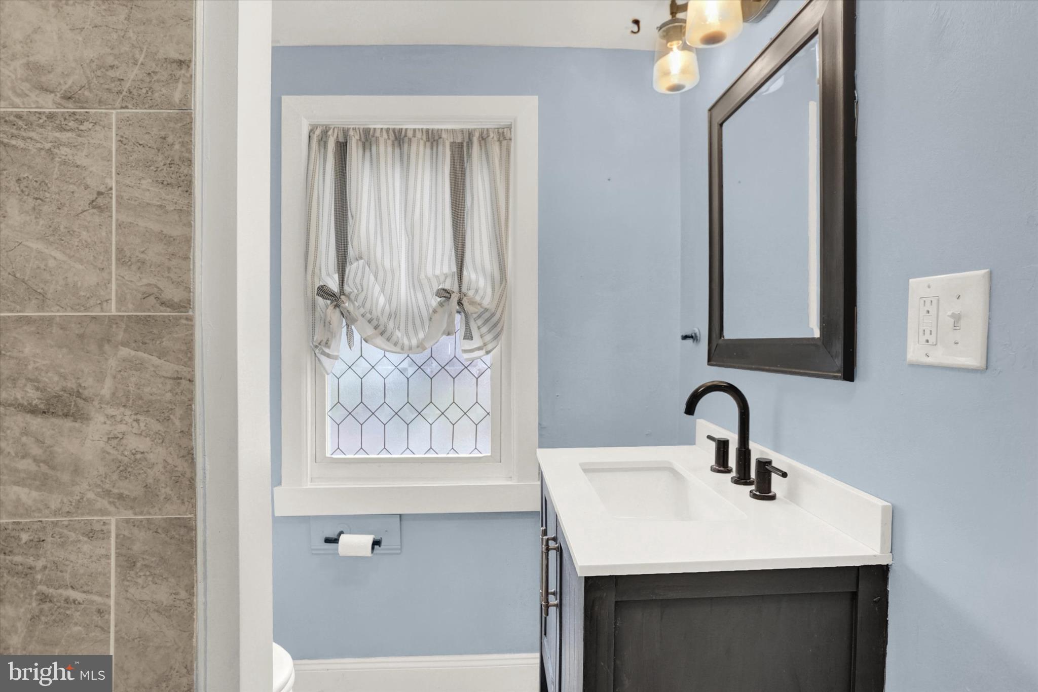 513 Poplar Street Lancaster, PA 17603 - Photo 30 of 41 a bathroom with a sink and a mirror