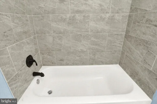 a view of walk in closet with clothes