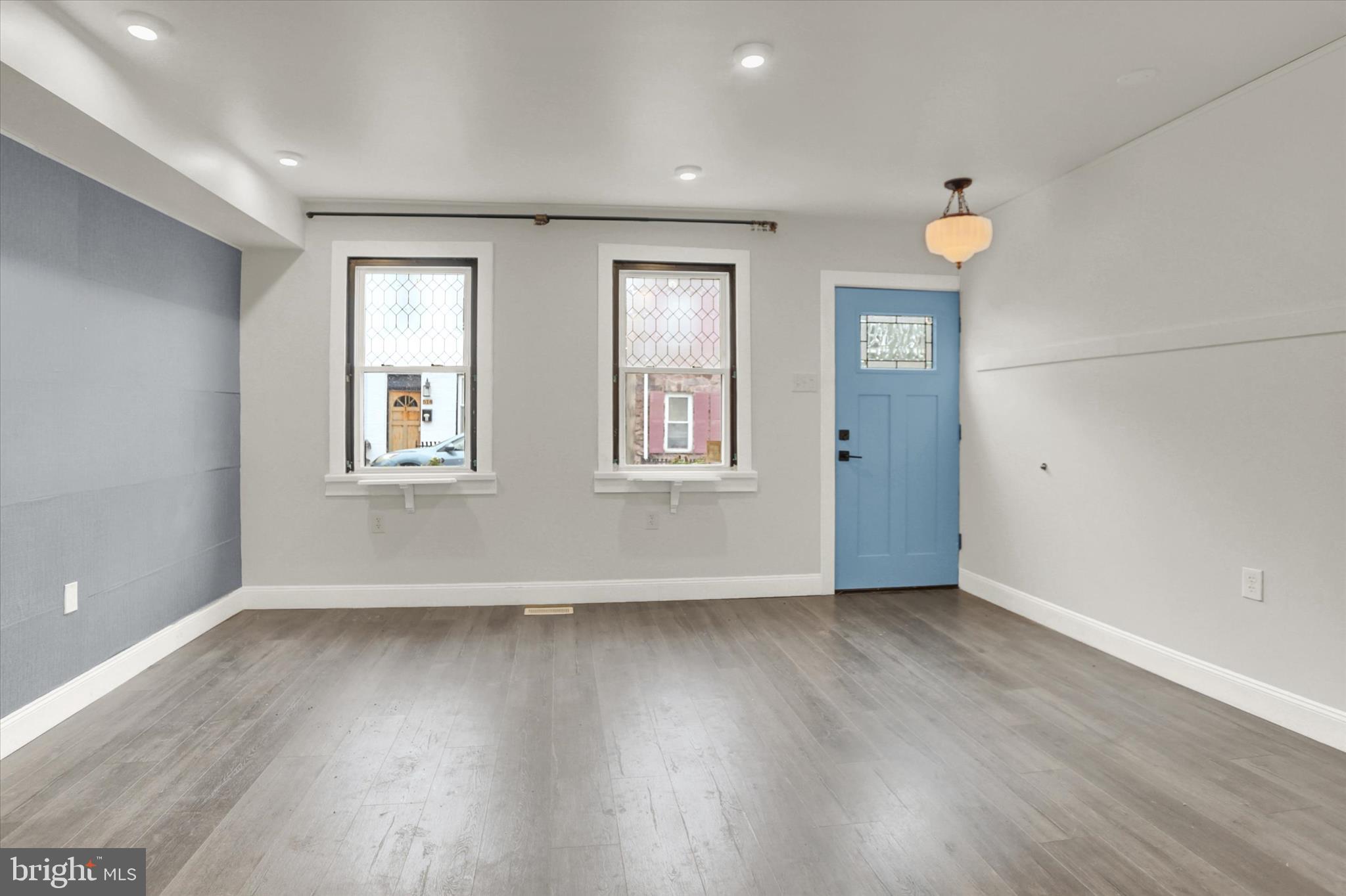 513 Poplar Street Lancaster, PA 17603 - Photo 6 of 41 an empty room with wooden floor and windows