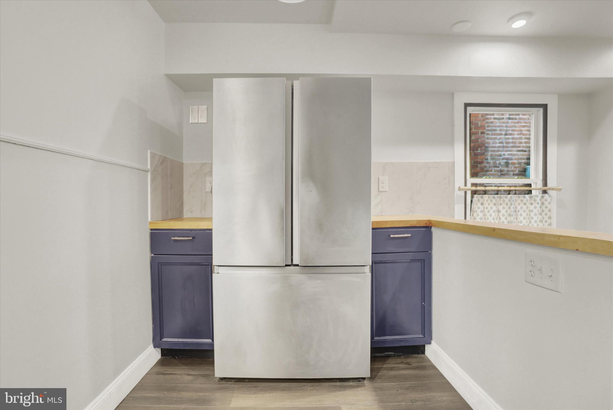 513 Poplar Street Lancaster, PA 17603 - Photo 10 of 41 a view of a refrigerator in kitchen and white cabinets