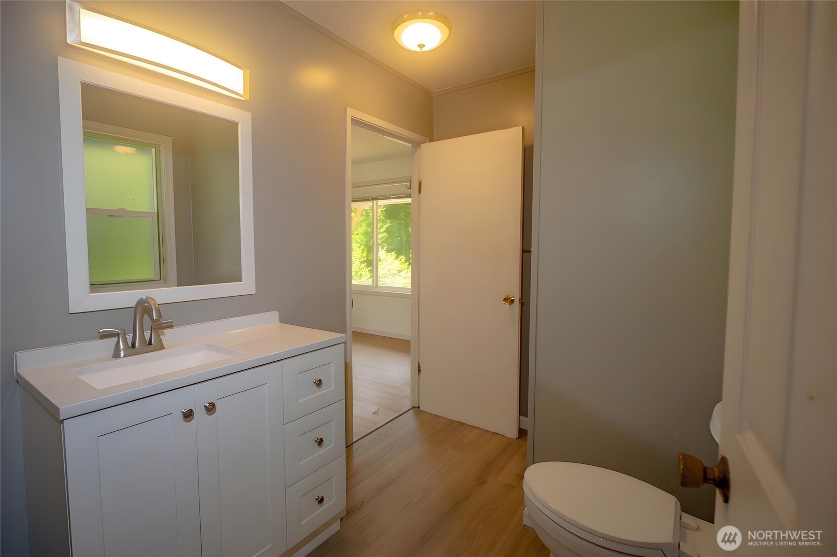 89 Slab Camp Road Sequim, WA 98382 - Photo 24 of 40 a bathroom with a granite countertop sink mirror vanity and toilet