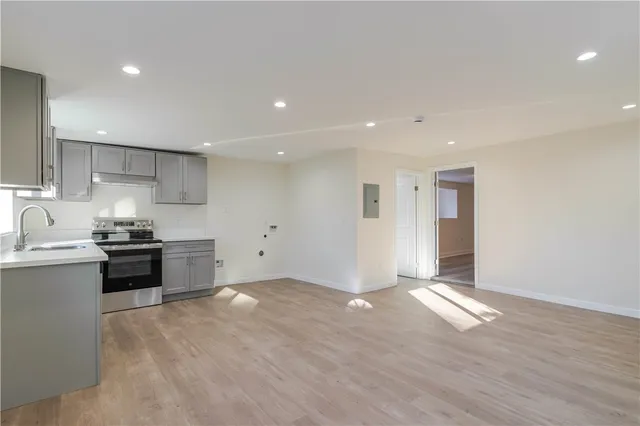 a kitchen with stainless steel appliances granite countertop a stove and a sink