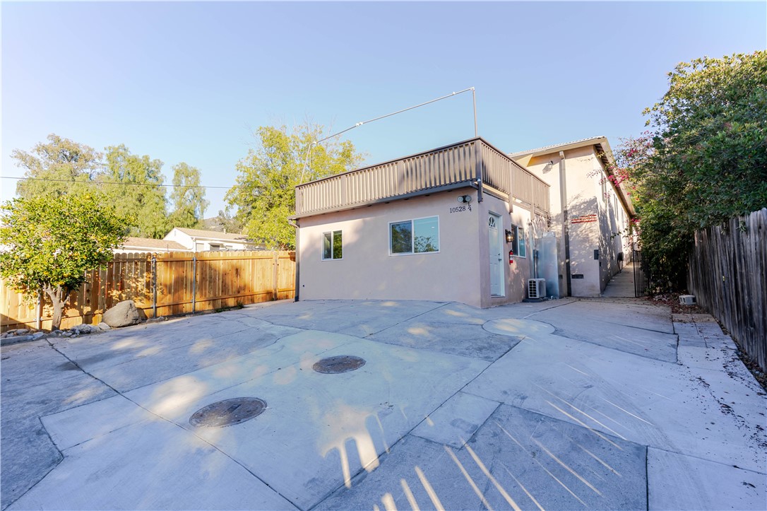 10528 1/4 Hillhaven Avenue Tujunga, CA 91042 - Photo 13 of 13 a view of a house with a yard and garage