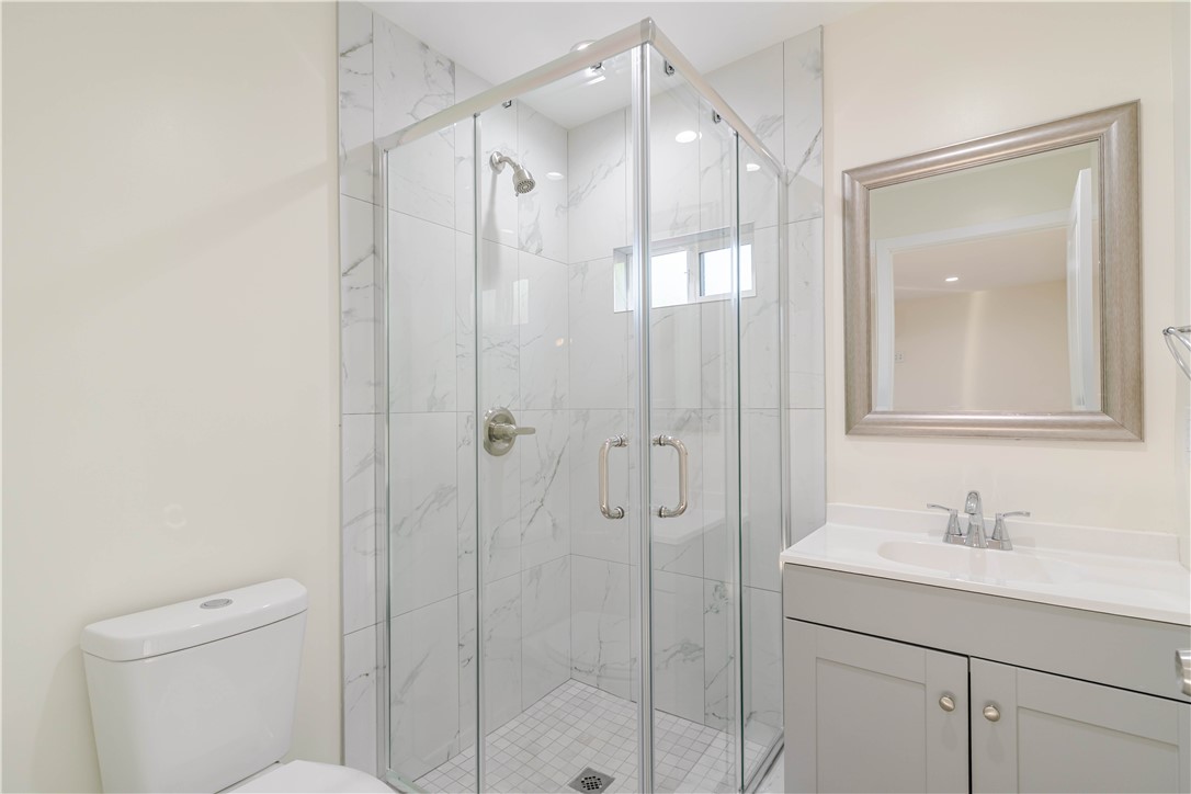 10528 1/4 Hillhaven Avenue Tujunga, CA 91042 - Photo 6 of 13 a bathroom with a shower sink vanity and mirror