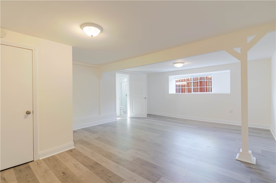 10528 1/4 Hillhaven Avenue Tujunga, CA 91042 - Photo 9 of 13 an empty room with wooden floor and windows