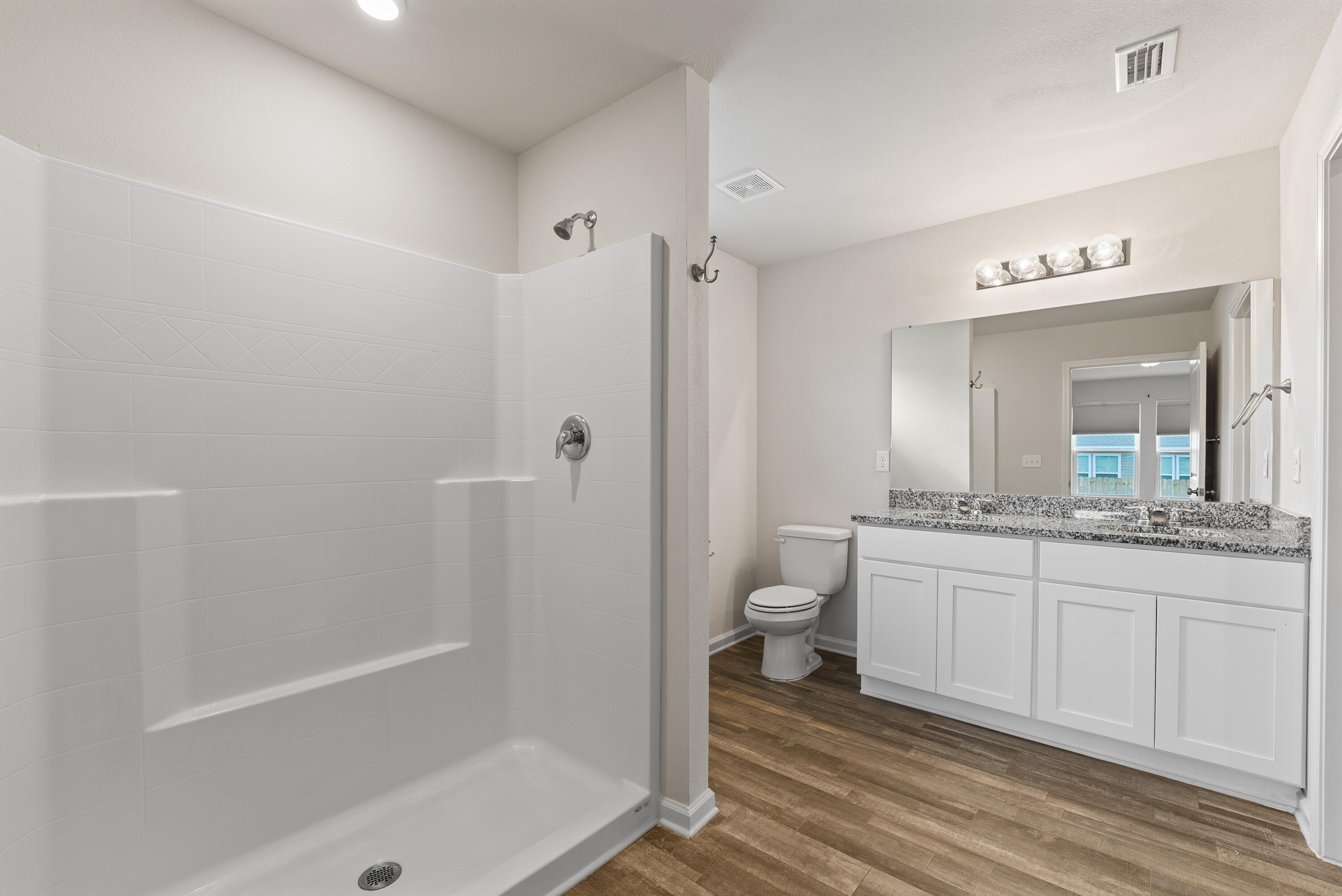 76 Cora Road DeFuniak Springs, FL 32433 - Photo 16 of 27 a bathroom with a granite countertop sink a toilet and shower