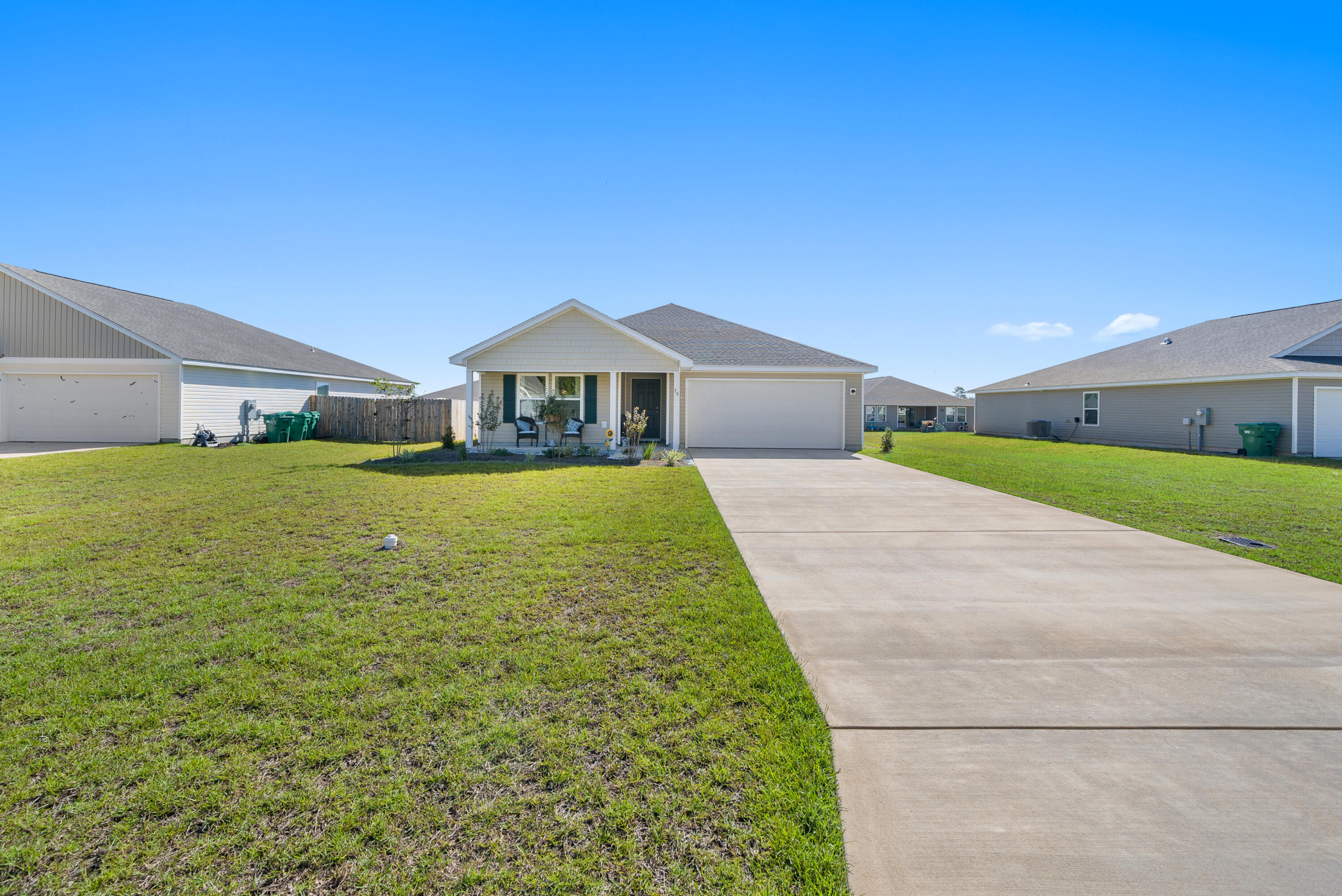 76 Cora Road DeFuniak Springs, FL 32433 - Photo 2 of 27 a large house with a big yard and large trees