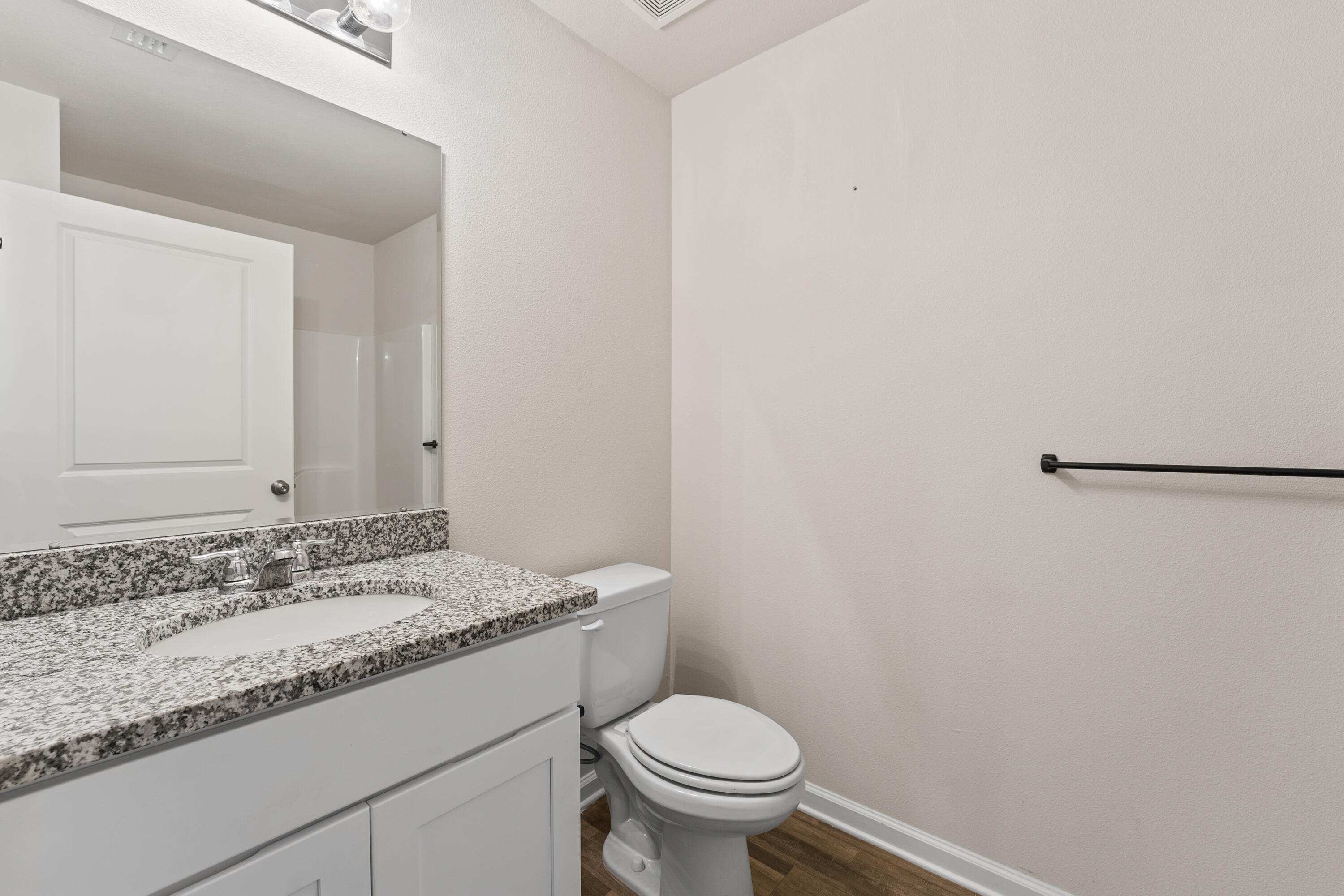 76 Cora Road DeFuniak Springs, FL 32433 - Photo 26 of 27 a bathroom with a granite countertop sink and a toilet