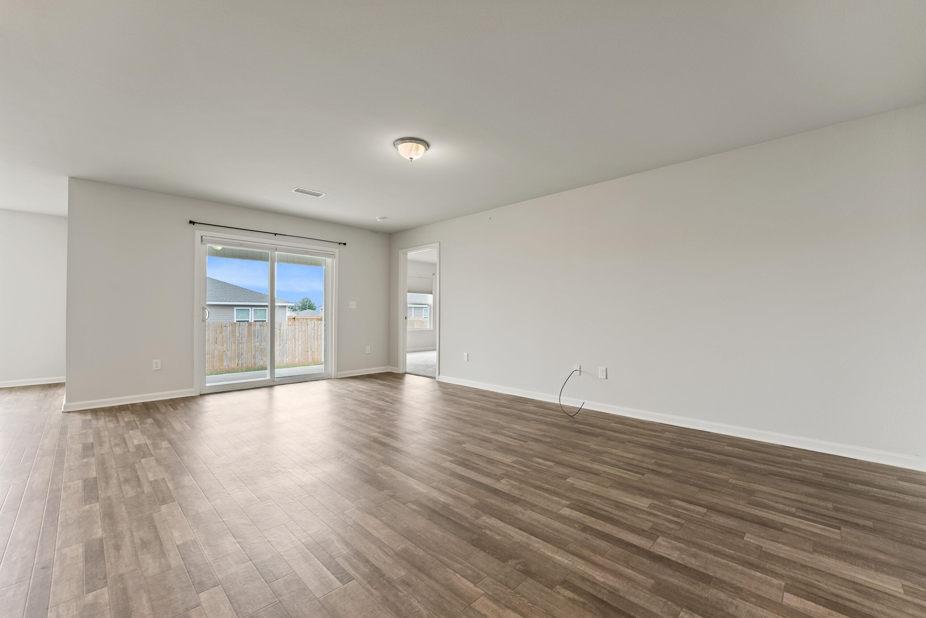 76 Cora Road DeFuniak Springs, FL 32433 - Photo 5 of 27 a view of an empty room with wooden floor and a window