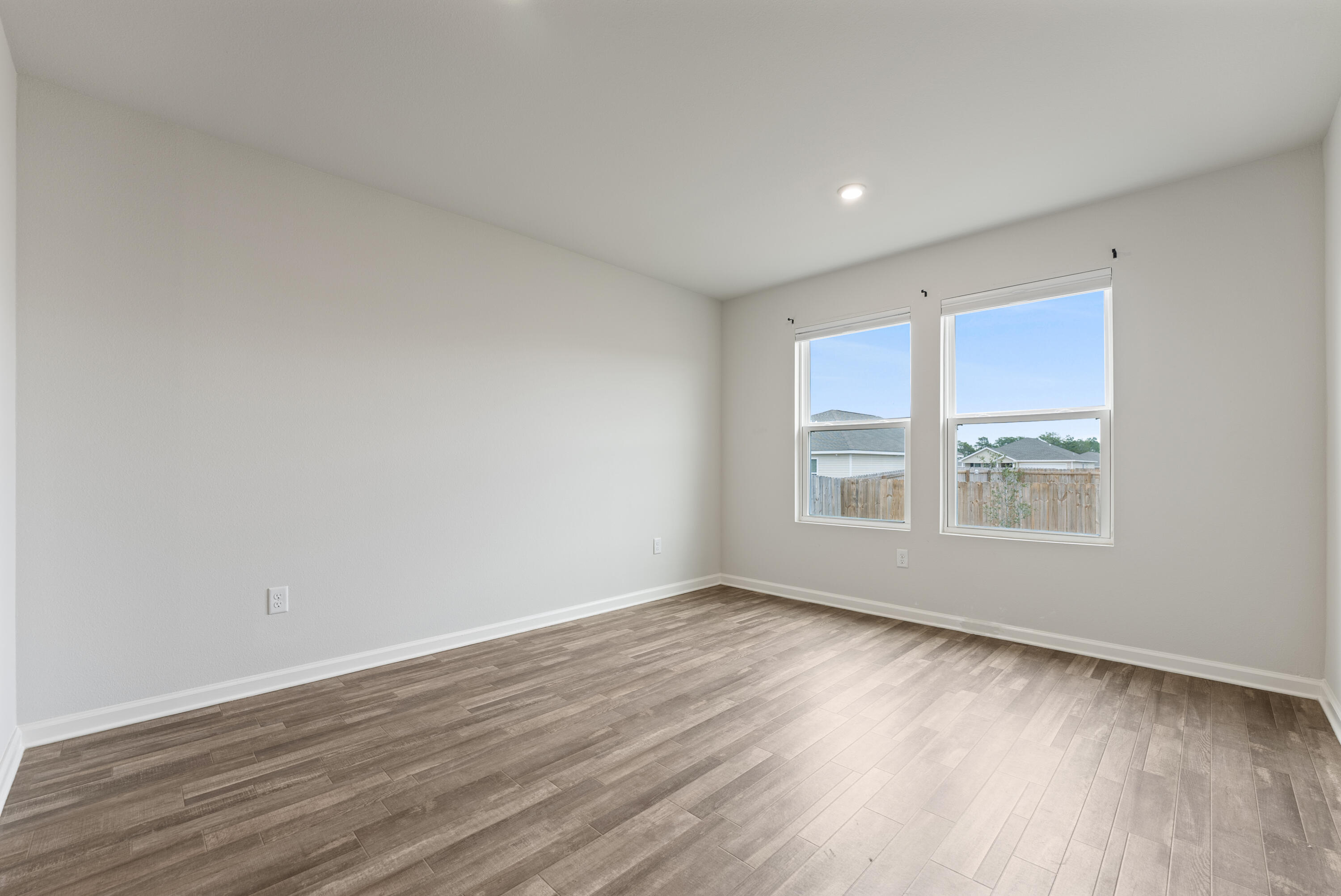 76 Cora Road DeFuniak Springs, FL 32433 - Photo 10 of 27 a view of an empty room with wooden floor and a window