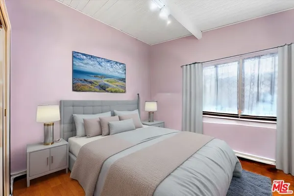 a bedroom with a bed and a large window
