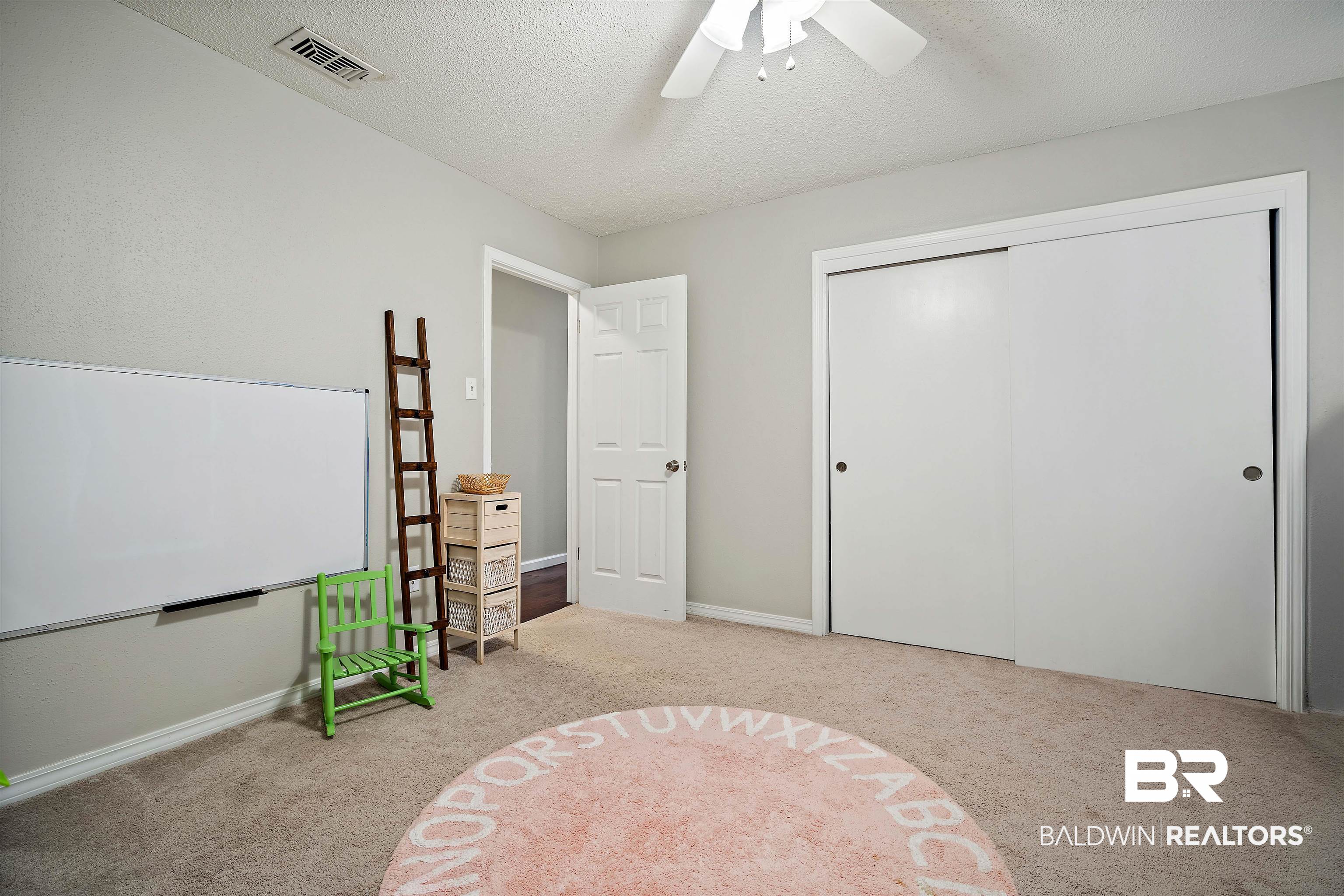 4228 Spring Valley Drive South Mobile, AL 36693 - Photo 20 of 31 Carpeted bedroom with ceiling fan, a textured ceiling, and a closet