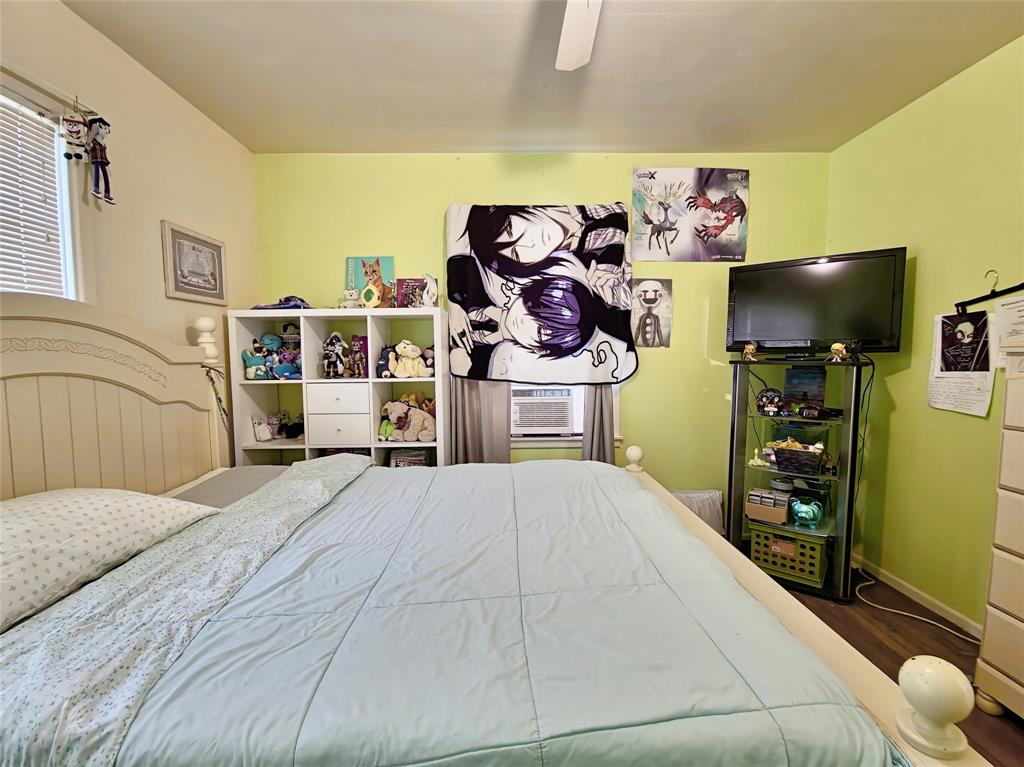 140 Meadowbrook Street Robinson, TX 76706 - Photo 12 of 37 a bedroom with a bed and a flat tv screen