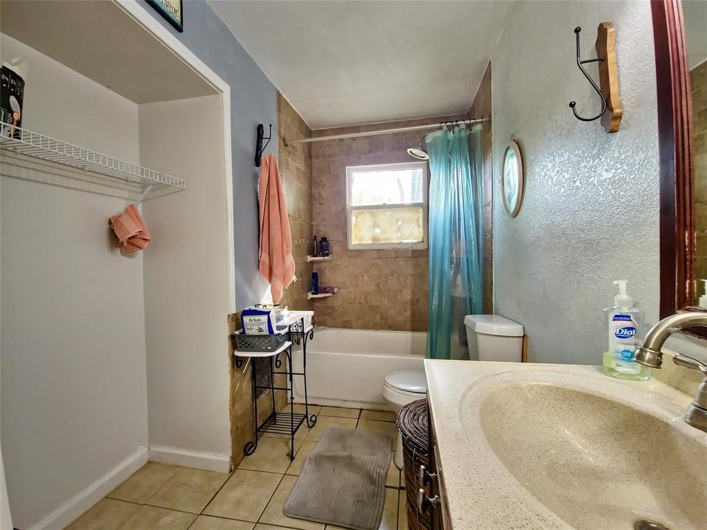 140 Meadowbrook Street Robinson, TX 76706 - Photo 15 of 37 a bathroom with a granite countertop sink and a mirror