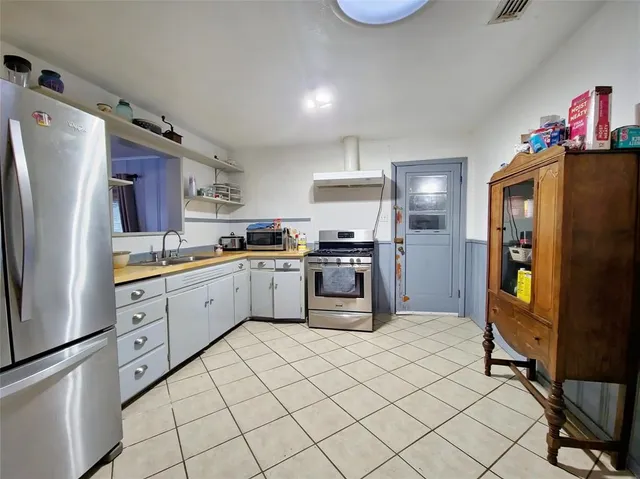 a kitchen with granite countertop cabinets a sink stainless steel appliances and counter space