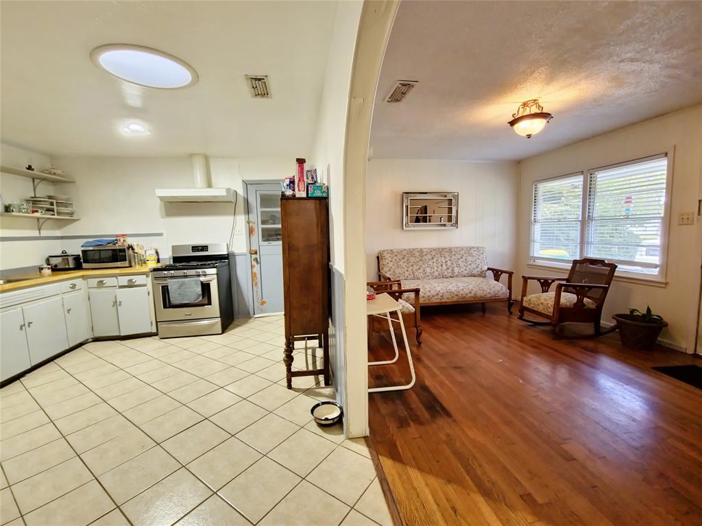 140 Meadowbrook Street Robinson, TX 76706 - Photo 33 of 37 a kitchen with furniture a refrigerator and a stove top oven
