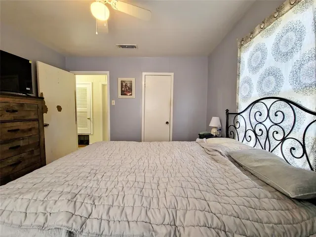 a bedroom with a bed and a television