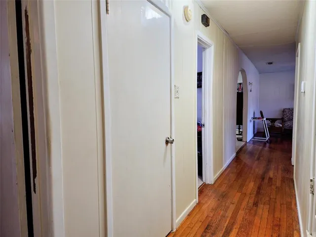 a view of hallway with wooden floor