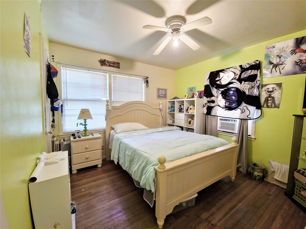 140 Meadowbrook Street Robinson, TX 76706 - Photo 10 of 37 a bedroom with a bed and wooden floor