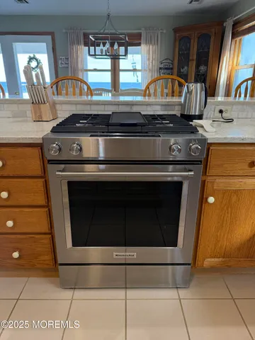 a stove top oven sitting inside of a kitchen