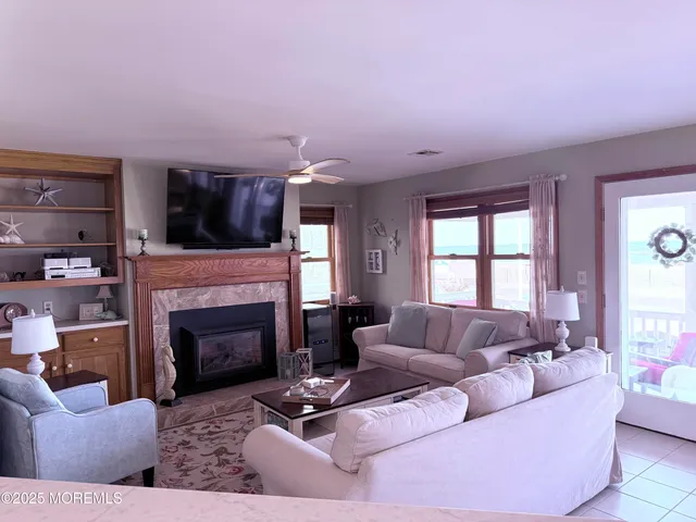 a living room with furniture flat screen tv and a fireplace