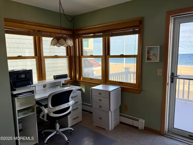 a view of a workspace with furniture and a window